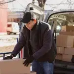 hombre junto a una furgoneta con cajas